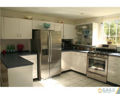 1 Chandler Road Edison, NJ 08820 - Photo 11 of 24 a kitchen with stainless steel appliances kitchen island granite countertop a refrigerator a stove and a sink with wooden floor