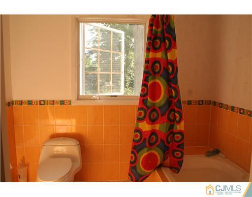 1 Chandler Road Edison, NJ 08820 - Photo 17 of 24 a bathroom with a sink and a shower curtain