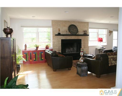 1 Chandler Road Edison, NJ 08820 - Photo 20 of 24 a living room with furniture and a fireplace