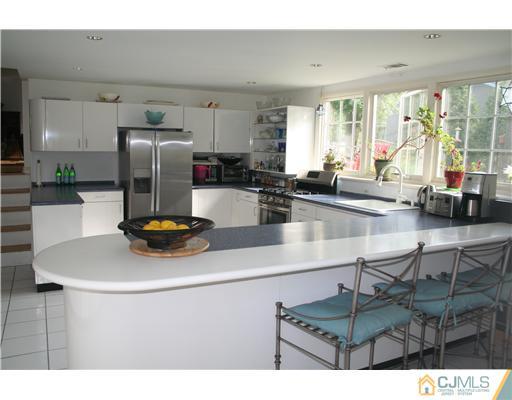 1 Chandler Road Edison, NJ 08820 - Photo 9 of 24 a kitchen with a refrigerator a stove and a sink with wooden floor