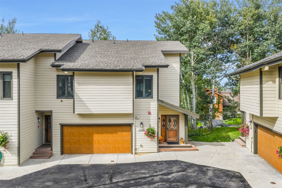 a front view of a house with a garden