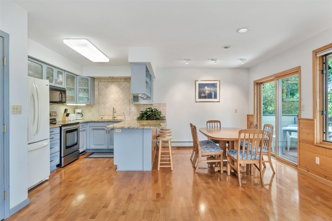 2116 Aster Place Steamboat Springs, CO 80487 - Photo 11 of 42 a kitchen with a table chairs refrigerator and cabinets