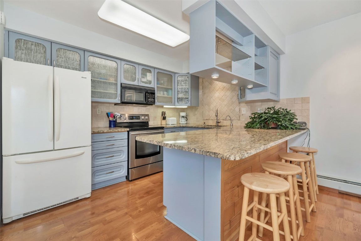 2116 Aster Place Steamboat Springs, CO 80487 - Photo 13 of 42 a kitchen with granite countertop a refrigerator and a stove