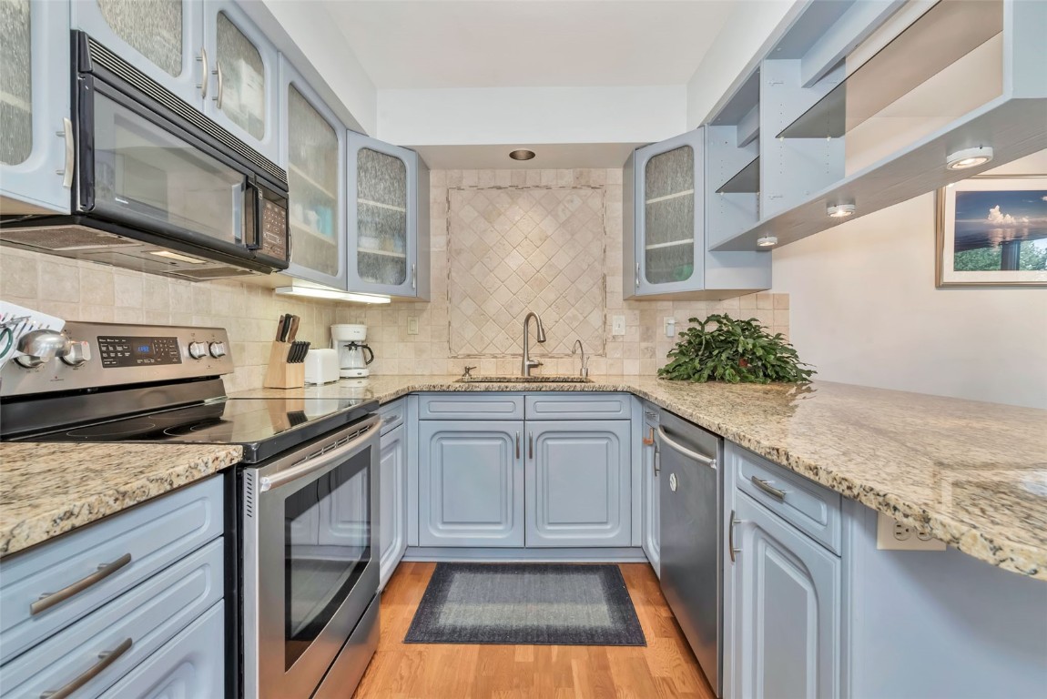 2116 Aster Place Steamboat Springs, CO 80487 - Photo 14 of 42 a kitchen with stainless steel appliances granite countertop a sink and a stove