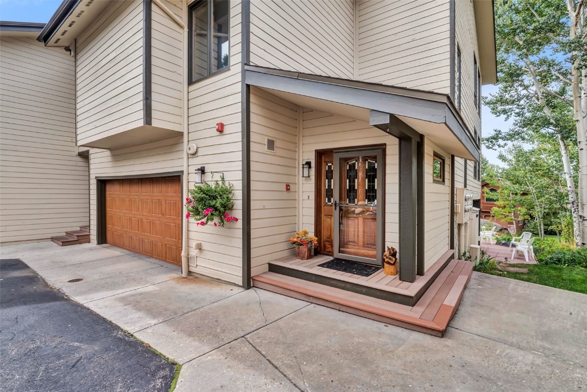 2116 Aster Place Steamboat Springs, CO 80487 - Photo 2 of 42 a view of a small house with a floor to ceiling window and brick wall