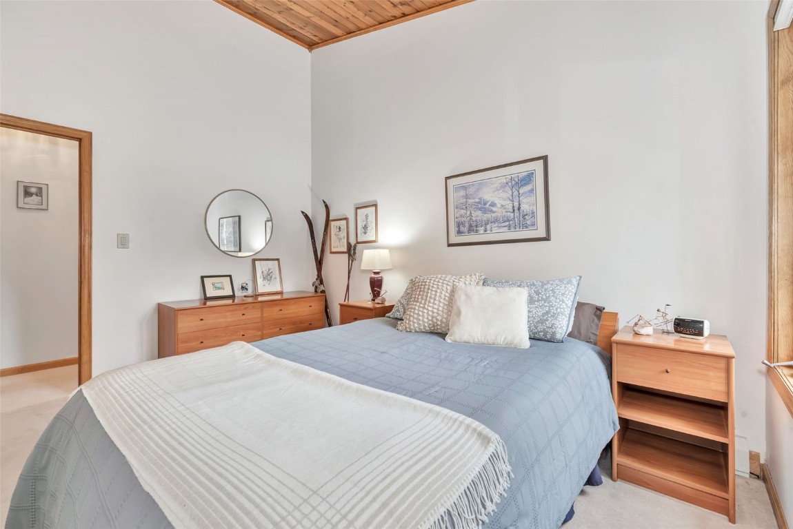 2116 Aster Place Steamboat Springs, CO 80487 - Photo 23 of 42 a bedroom with a bed and dresser