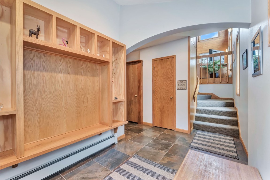 2116 Aster Place Steamboat Springs, CO 80487 - Photo 3 of 42 a view of a hallway with wooden floor and staircase