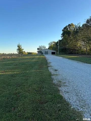 a view of a field with an ocean view