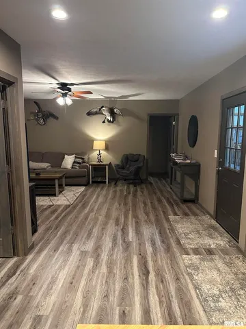 a living room with furniture and a chandelier