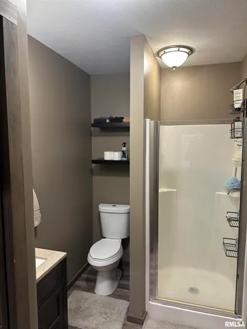 a bathroom with a toilet and a glass door