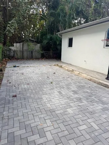 a view of backyard with plants and trees