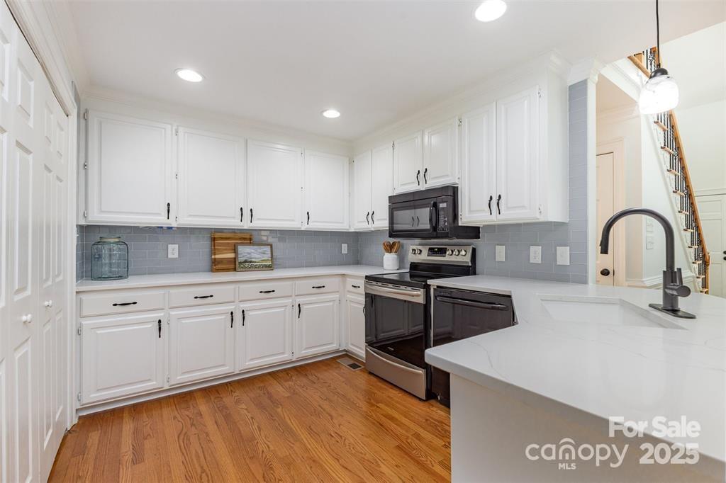6639 Camp Creek Road Lancaster, SC 29720 - Photo 11 of 42 a kitchen with stainless steel appliances granite countertop a stove a sink and a microwave