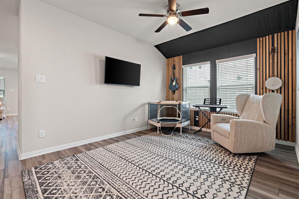 3112 Kingsgarden Road Denton, TX 76207 - Photo 16 of 38 Room featuring wood-finish flooring, a ceiling fan with integrated lighting, and dual windows equipped with blinds