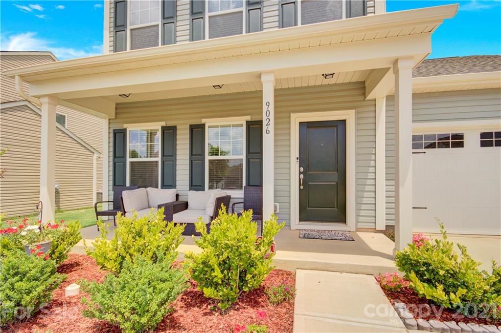 9026 Colwick Hill Road Charlotte, NC 28215 - Photo 2 of 21 a front view of a house with a flower garden