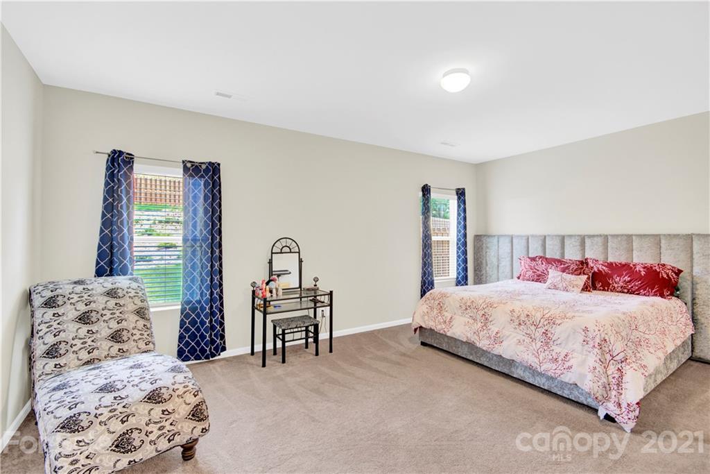 9026 Colwick Hill Road Charlotte, NC 28215 - Photo 12 of 21 a bedroom with a large bed and a large window