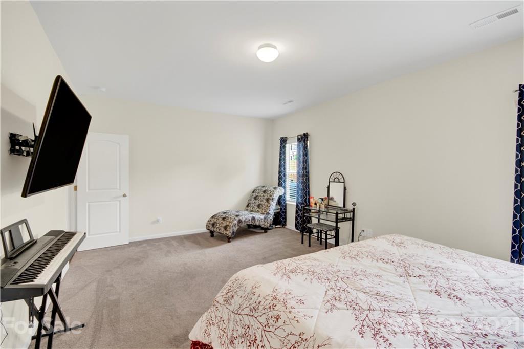 9026 Colwick Hill Road Charlotte, NC 28215 - Photo 13 of 21 a bedroom with a bed and a flat screen tv