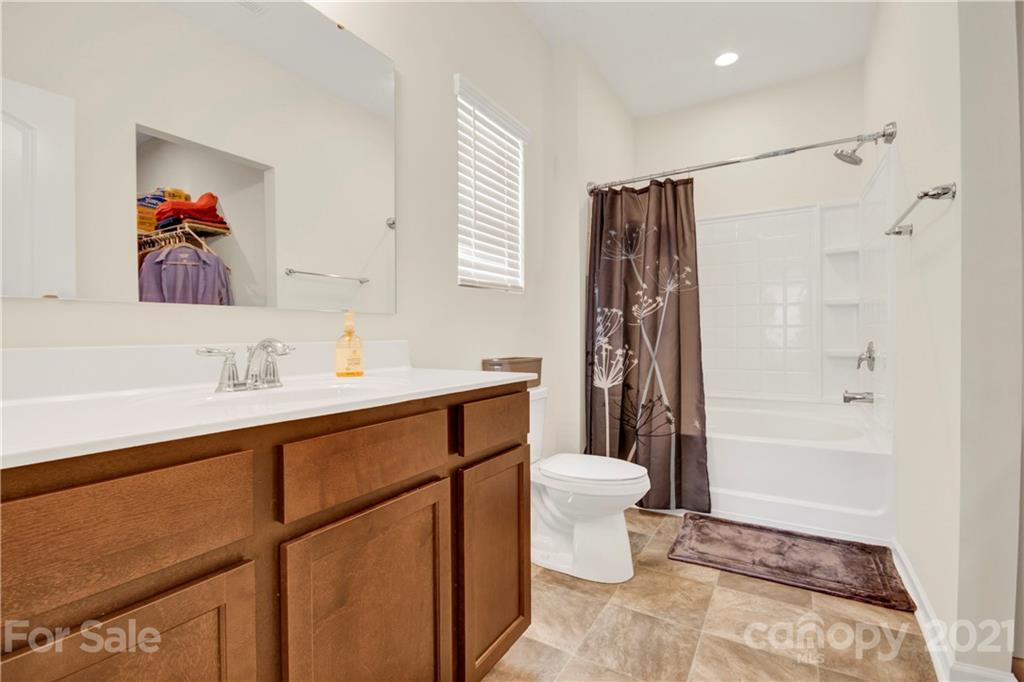 9026 Colwick Hill Road Charlotte, NC 28215 - Photo 14 of 21 a bathroom with a sink a toilet and shower