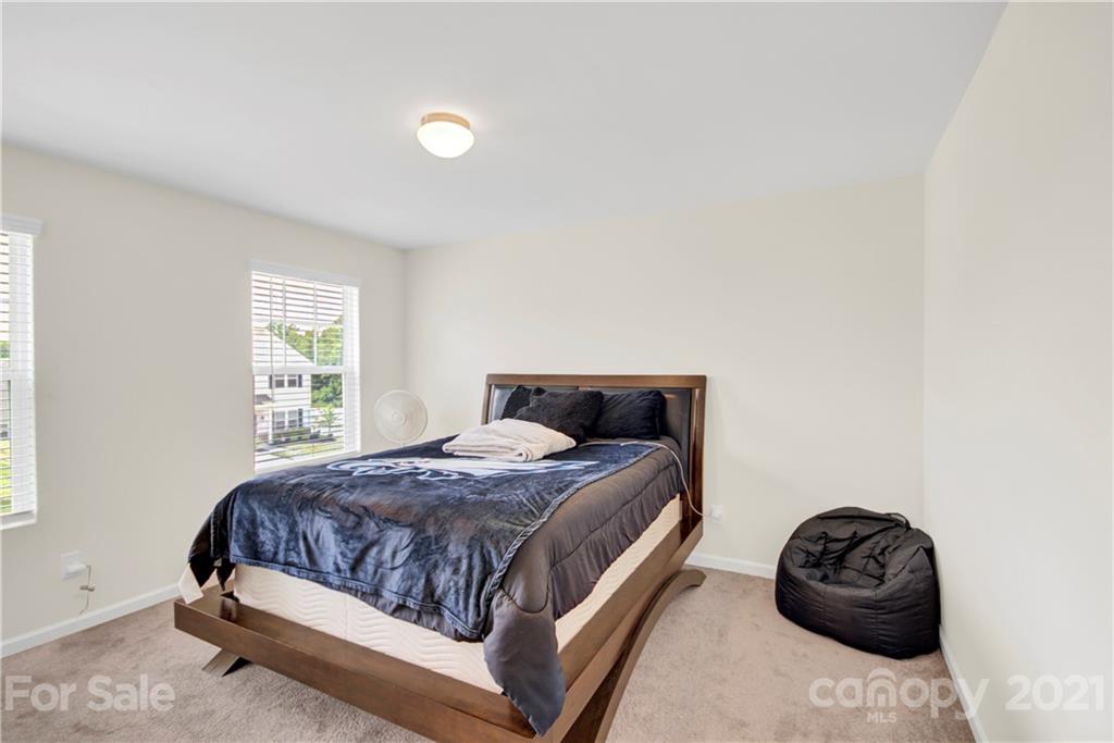 9026 Colwick Hill Road Charlotte, NC 28215 - Photo 15 of 21 a bedroom with a bed and a window