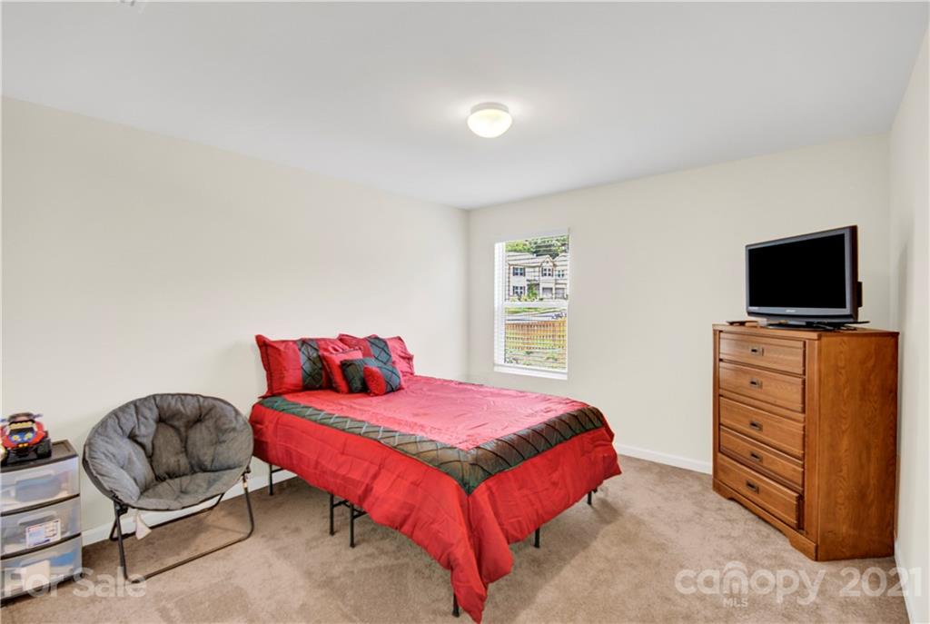 9026 Colwick Hill Road Charlotte, NC 28215 - Photo 16 of 21 a bedroom with a bed and flat screen tv