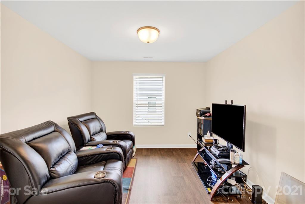 9026 Colwick Hill Road Charlotte, NC 28215 - Photo 18 of 21 a living room with furniture a ceiling fan and a window