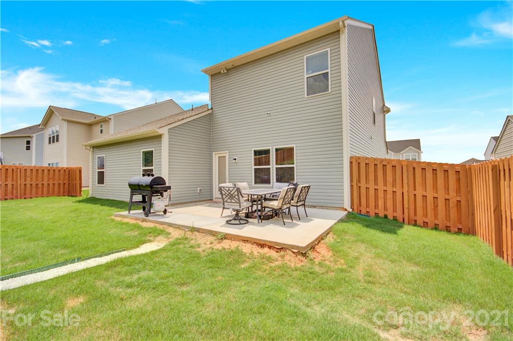 9026 Colwick Hill Road Charlotte, NC 28215 - Photo 19 of 21 a view of a backyard with table and chairs with wooden fence