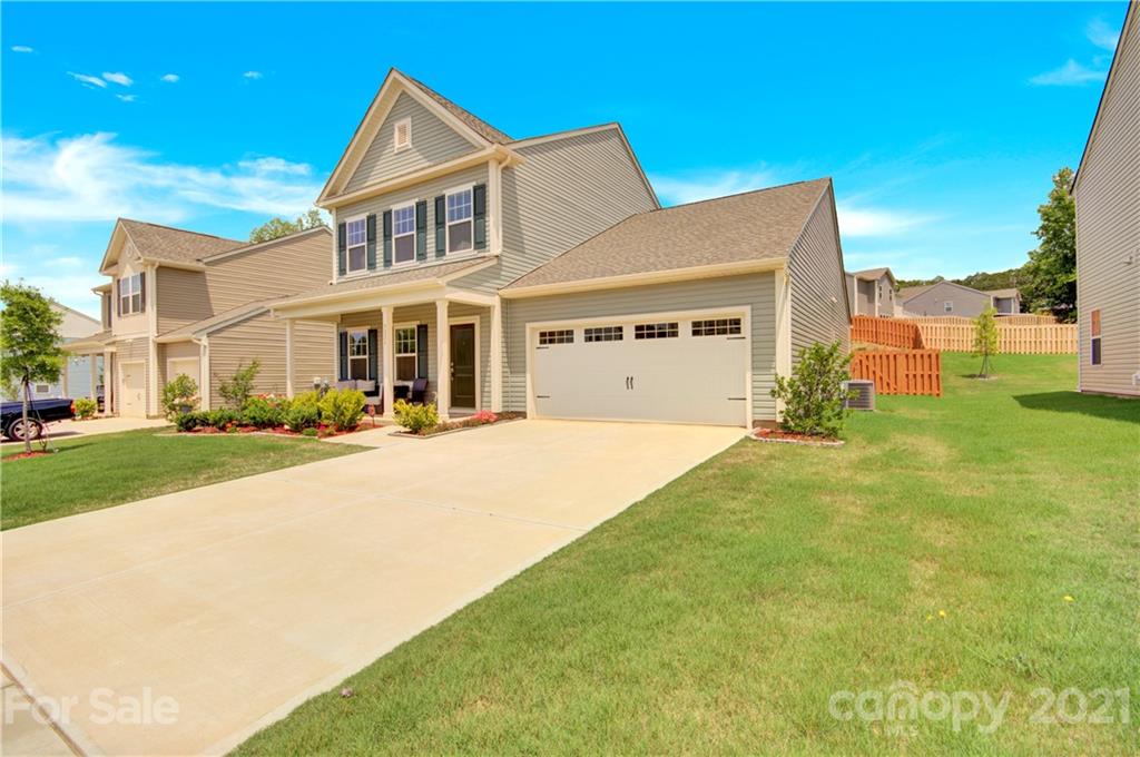 9026 Colwick Hill Road Charlotte, NC 28215 - Photo 3 of 21 a front view of a house with a yard and potted plants