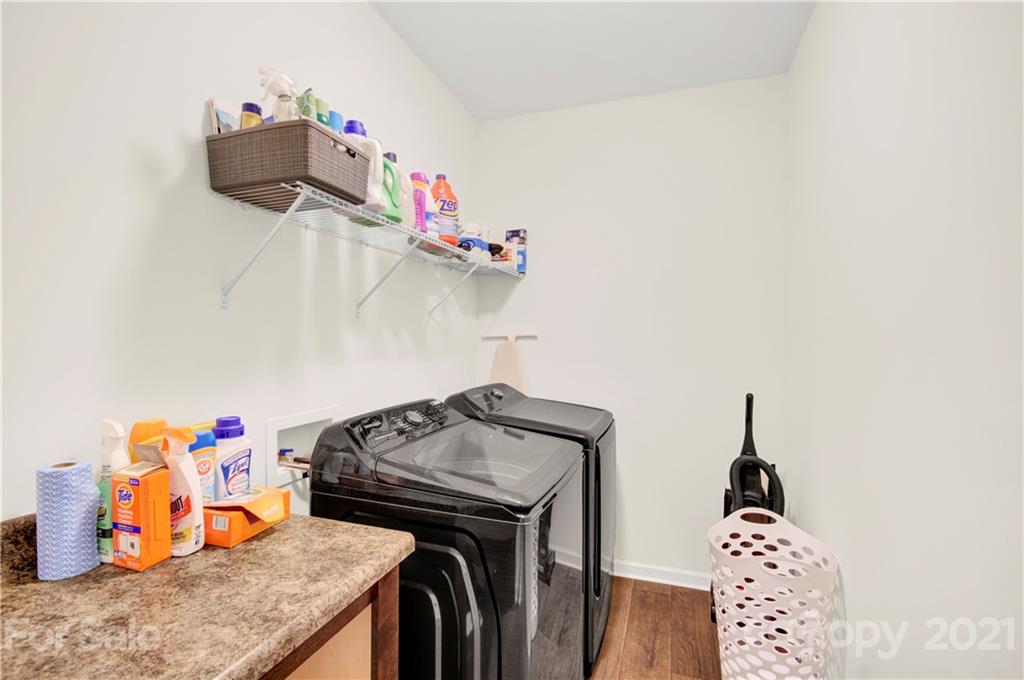 9026 Colwick Hill Road Charlotte, NC 28215 - Photo 21 of 21 a utility room with a sink dryer and washer