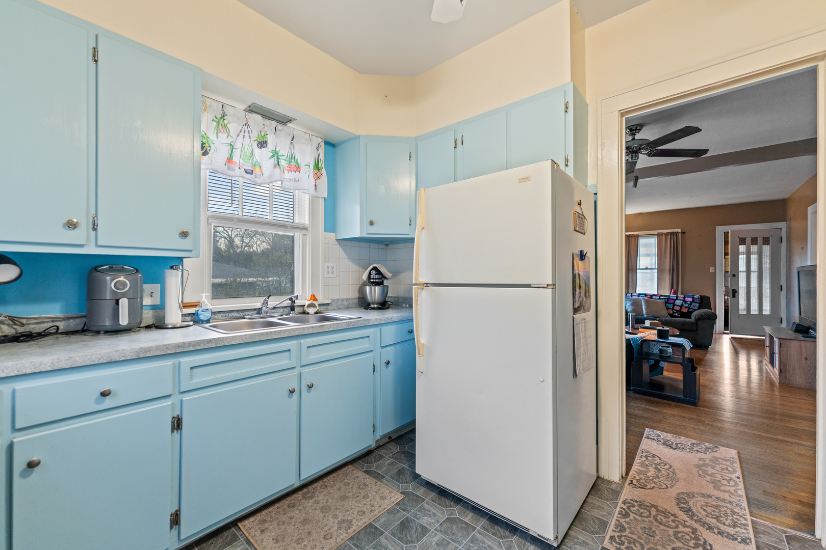 1100 Sycamore Road DeKalb, IL 60115 - Photo 8 of 24 a kitchen with refrigerator and cabinets