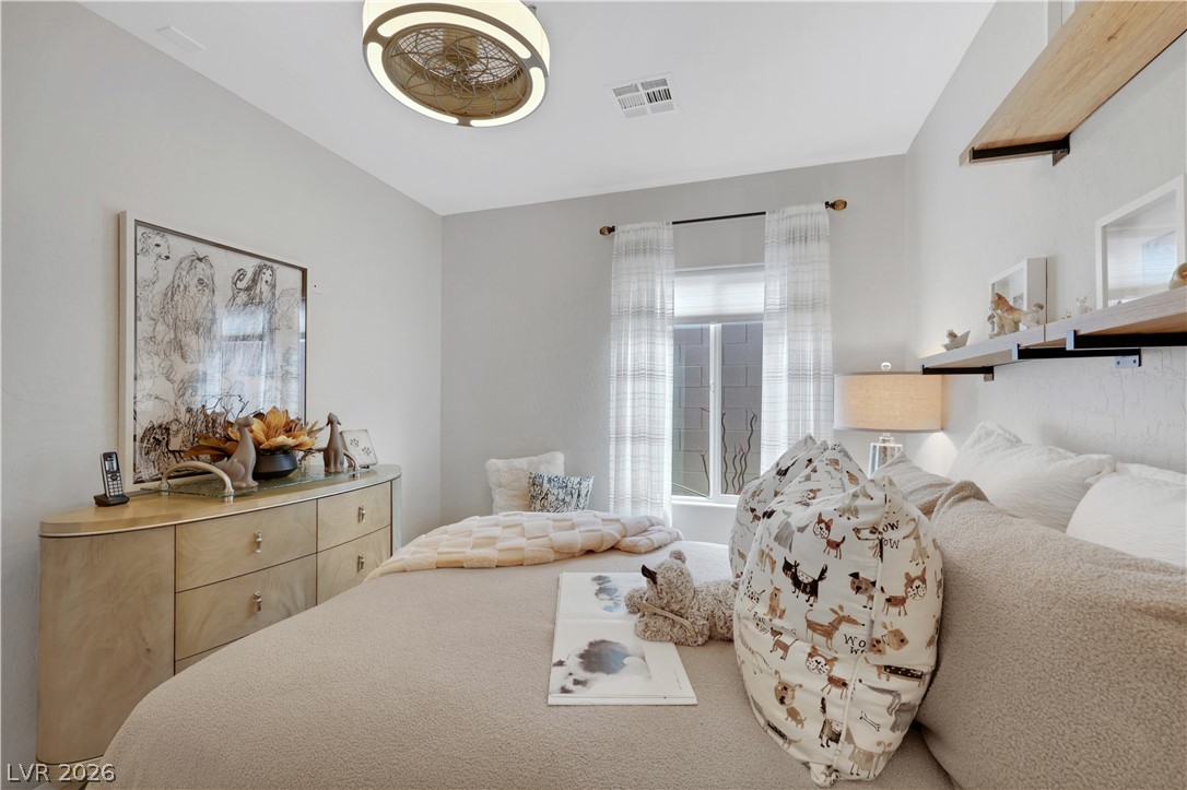 2635 Dirleton Place Henderson, NV 89044 - Photo 33 of 50 Smooth plaster walls and a wide window create a peaceful setting in this comfortable bedroom.