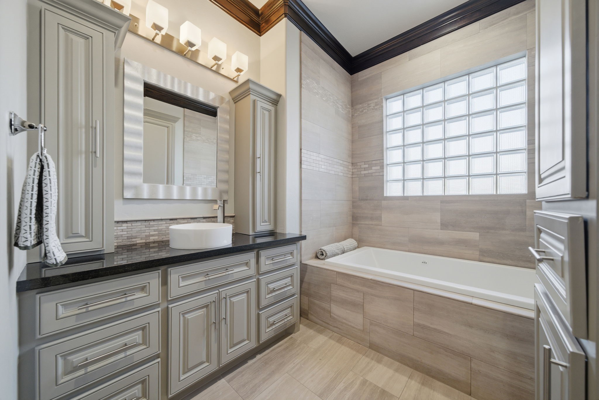15 Royal King Road Tomball, TX 77377 - Photo 26 of 50 a bathroom with a bathtub a sink and a window