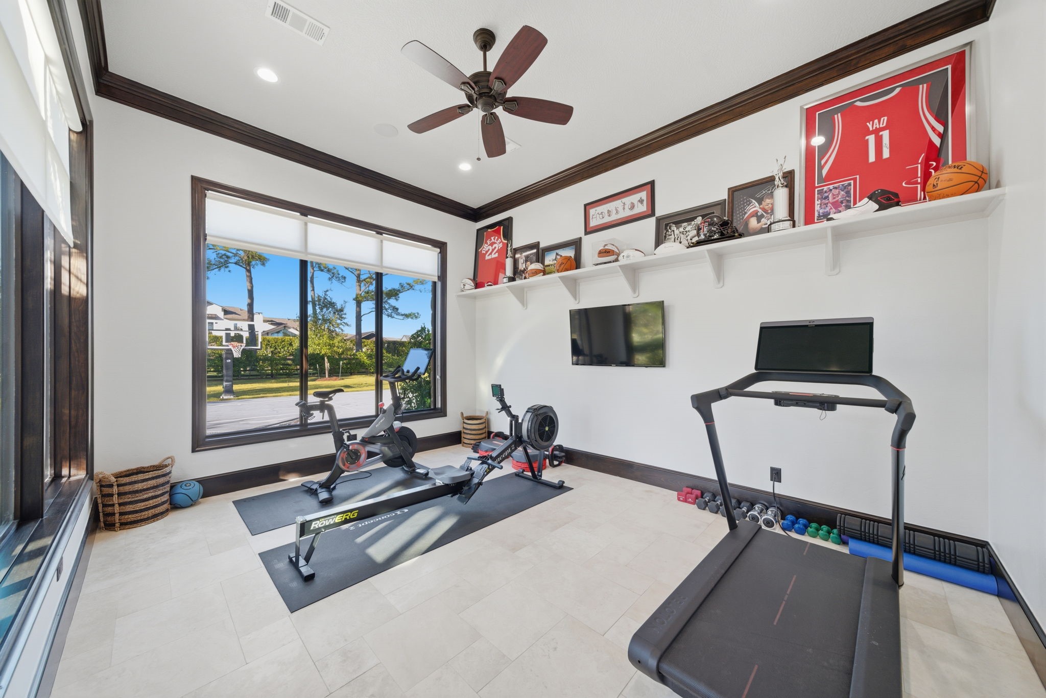 15 Royal King Road Tomball, TX 77377 - Photo 30 of 50 a room with gym equipment and a large window