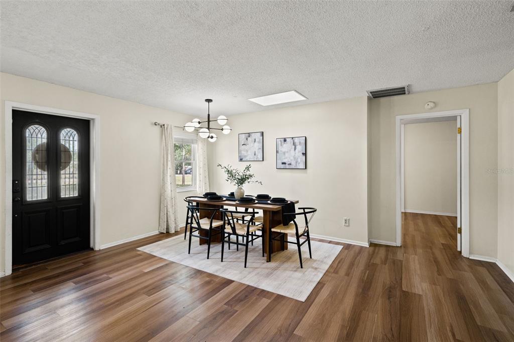 2111 Hinson Road Dover, FL 33527 - Photo 16 of 45 a view of a dining room with furniture and wooden floor