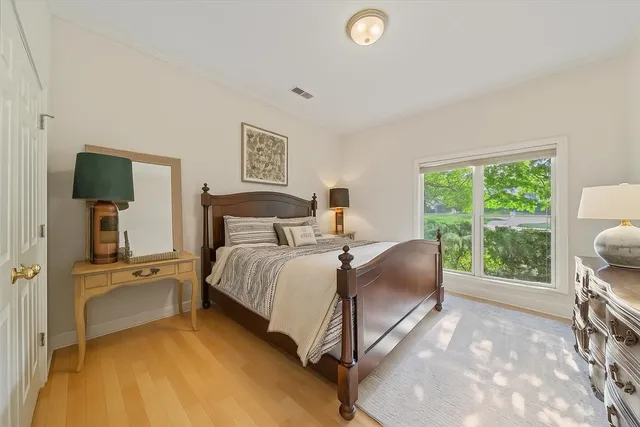 a bedroom with a bed and a large window