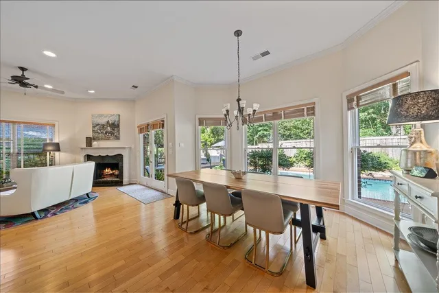 a living room with furniture a fireplace and a floor to ceiling window