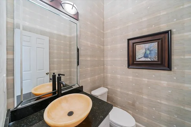 a bathroom with a toilet sink and mirror