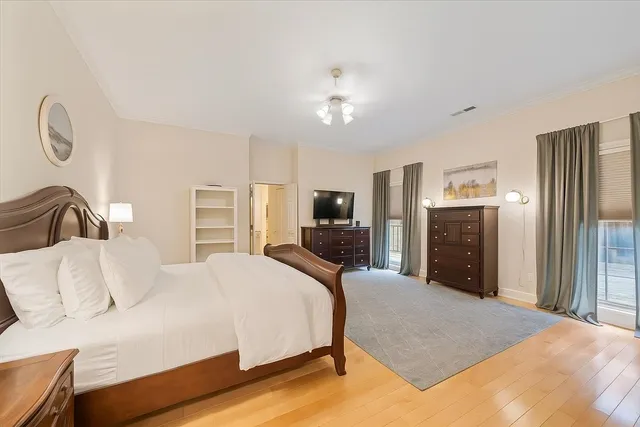 a bedroom with a large bed and flat screen tv