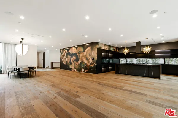 a view of kitchen with stainless steel appliances living room