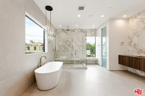 a bathroom with a granite countertop sink a mirror and vanity