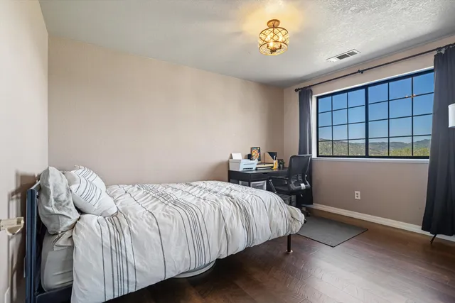 a bedroom with a bed and a window