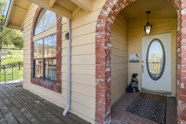 a view of a hallway with wooden floor and a fireplace