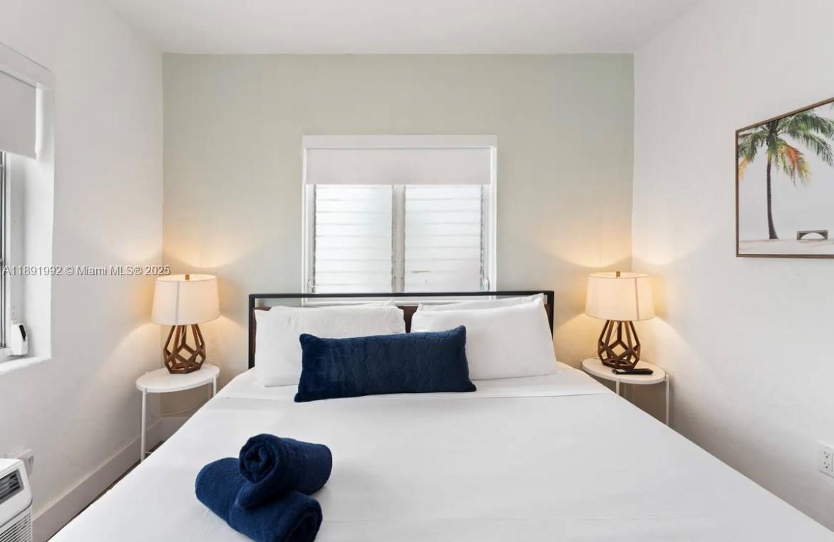 7721 Harding Avenue, Unit 4 Miami Beach, FL 33141 - Photo 13 of 16 a bedroom with a bed and window