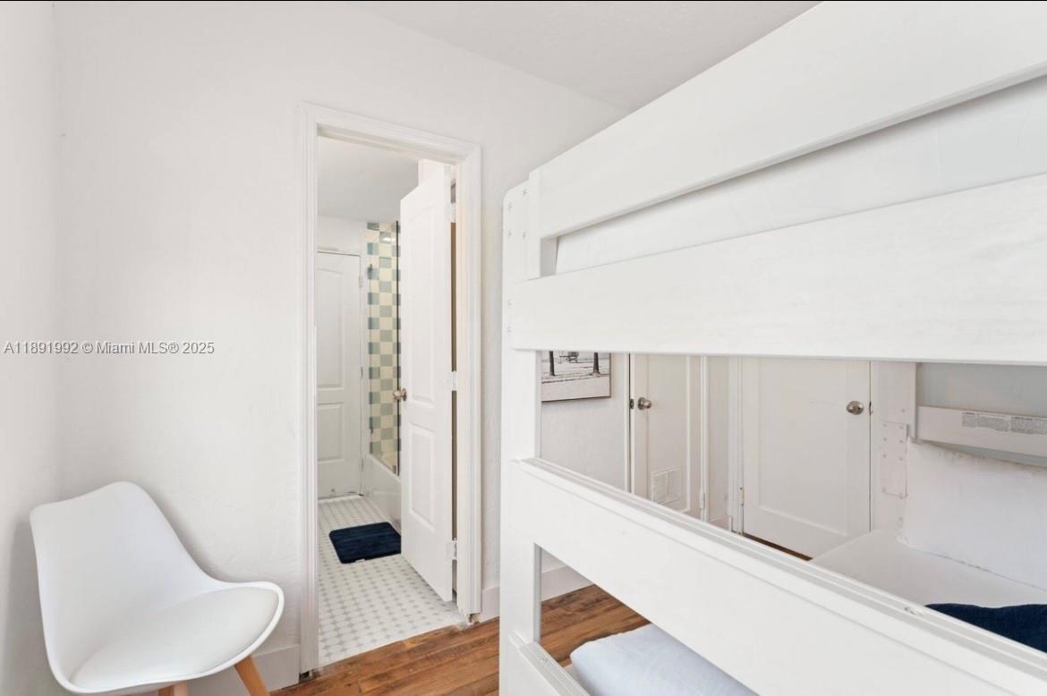 7721 Harding Avenue, Unit 4 Miami Beach, FL 33141 - Photo 16 of 16 a bathroom with a toilet tub and shower