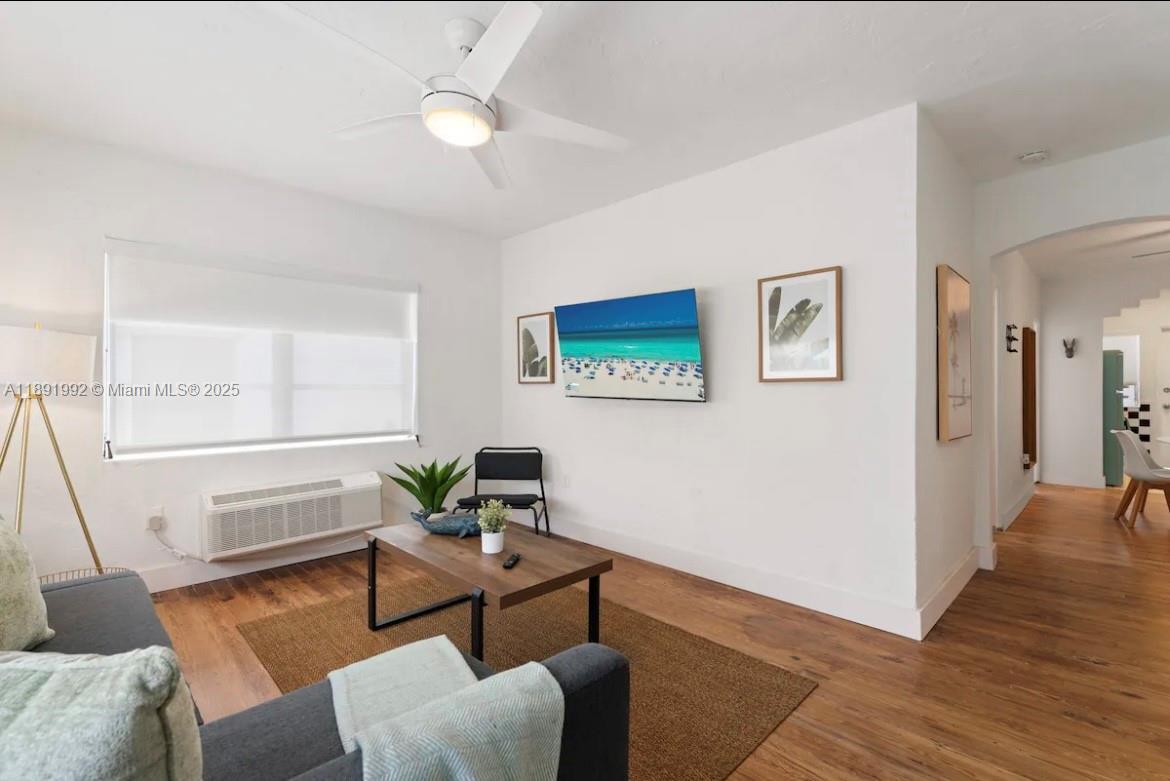 7721 Harding Avenue, Unit 4 Miami Beach, FL 33141 - Photo 2 of 16 a living room with furniture and wooden floor