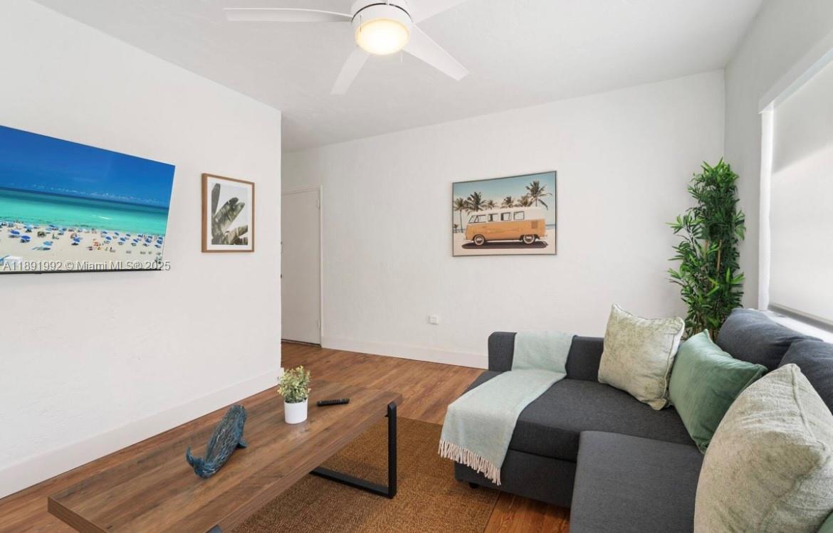 7721 Harding Avenue, Unit 4 Miami Beach, FL 33141 - Photo 4 of 16 a living room with furniture and a potted plant