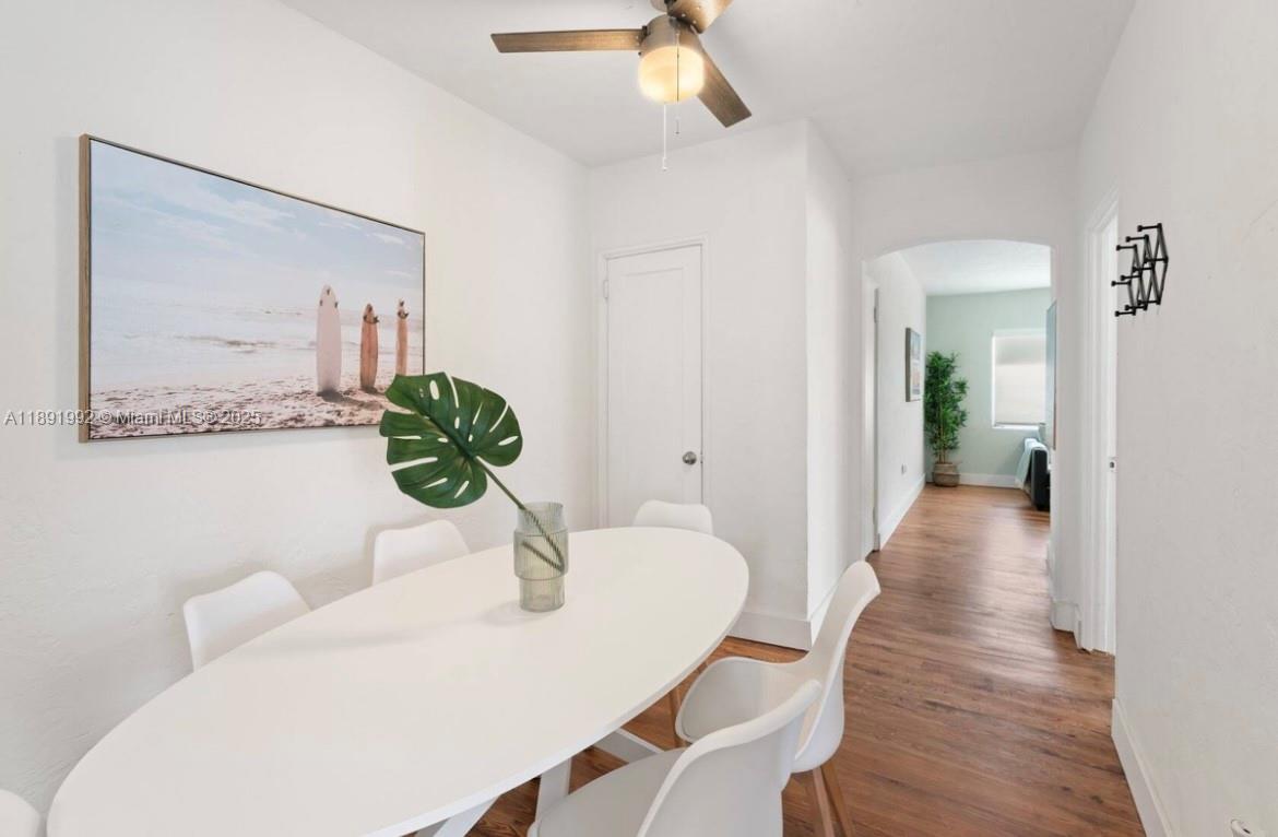 7721 Harding Avenue, Unit 4 Miami Beach, FL 33141 - Photo 9 of 16 a view of a dining room with furniture and wooden floor