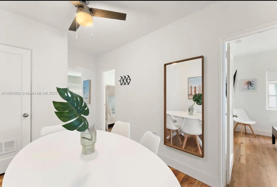 7721 Harding Avenue, Unit 4 Miami Beach, FL 33141 - Photo 10 of 16 a dining room with table and wooden floor