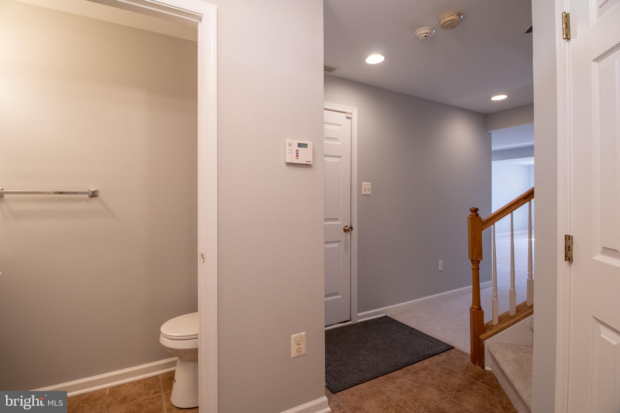 98 Lullwater Way Falling Waters, WV 25419 - Photo 5 of 43 a bathroom with a granite countertop sink a toilet and a mirror