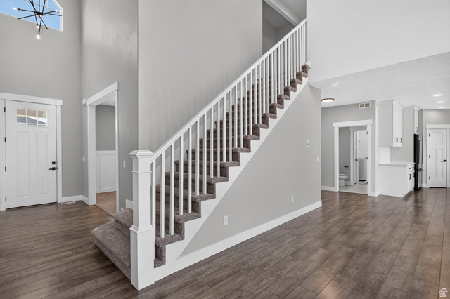 36 West Syracuse Road Vineyard, UT 84059 - Photo 33 of 56 Open concept living area featuring a carpeted staircase with white balusters