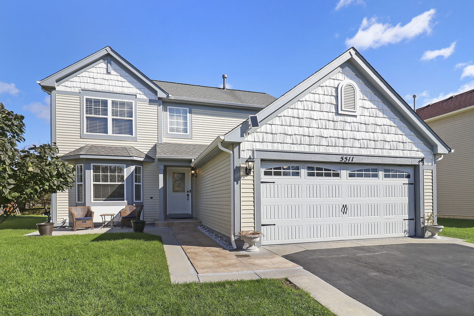 a front view of a house with a garden