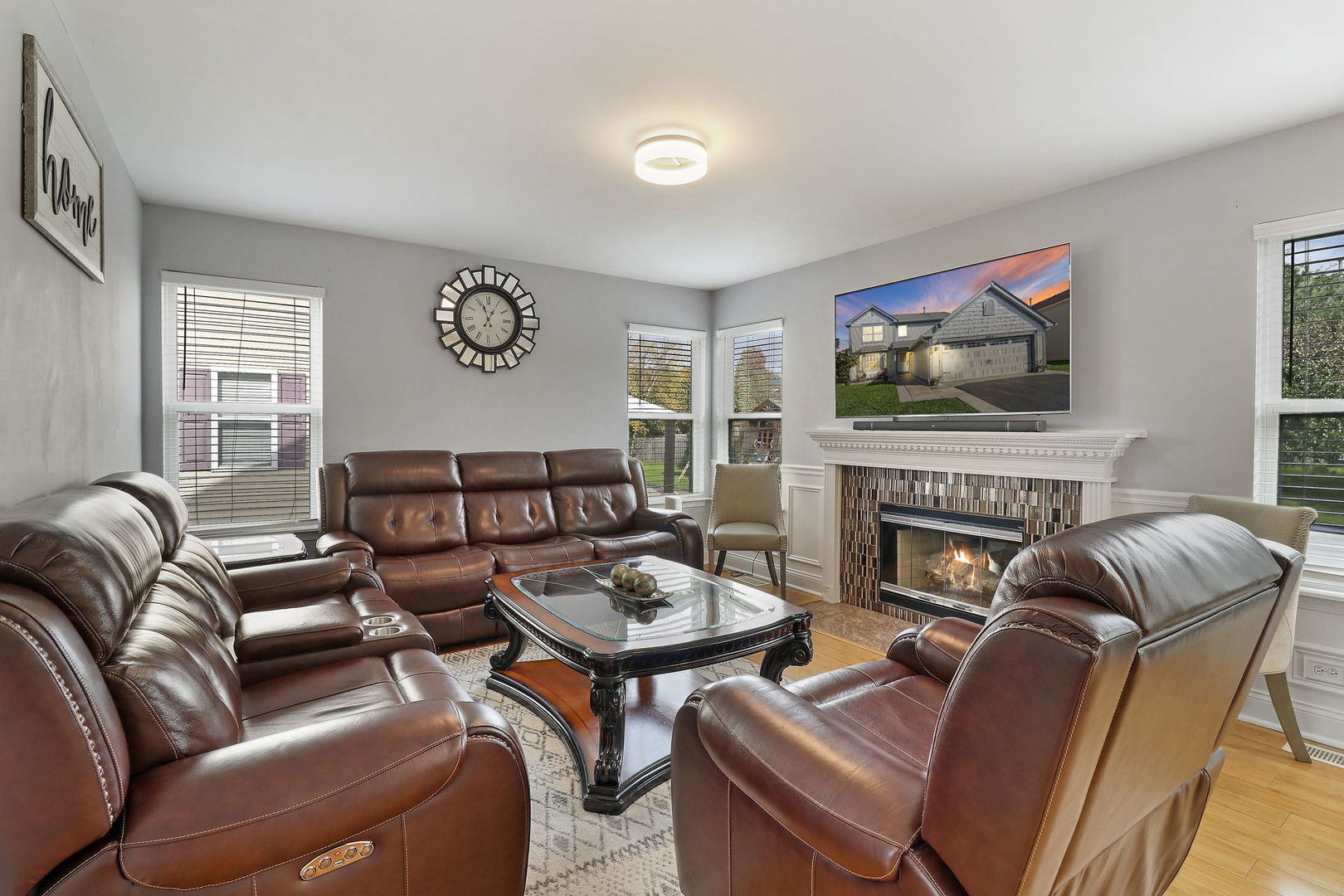 5511 Windgate Way Lake In The Hills, IL 60156 - Photo 11 of 30 a living room with furniture a fireplace and a flat screen tv